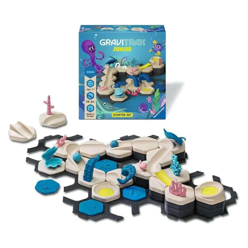 GraviTrax Junior Ocean Starter Set box with blue ocean theme and colorful sea creatures, displayed with track tiles, ramps, coral, and marine animal decorations.