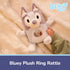 Bluey plush ring rattle is shown in a lifestyle setting on a cozy surface, highlighting its soft pastel fabric, compact size, and baby-safe design for everyday snuggles and play.