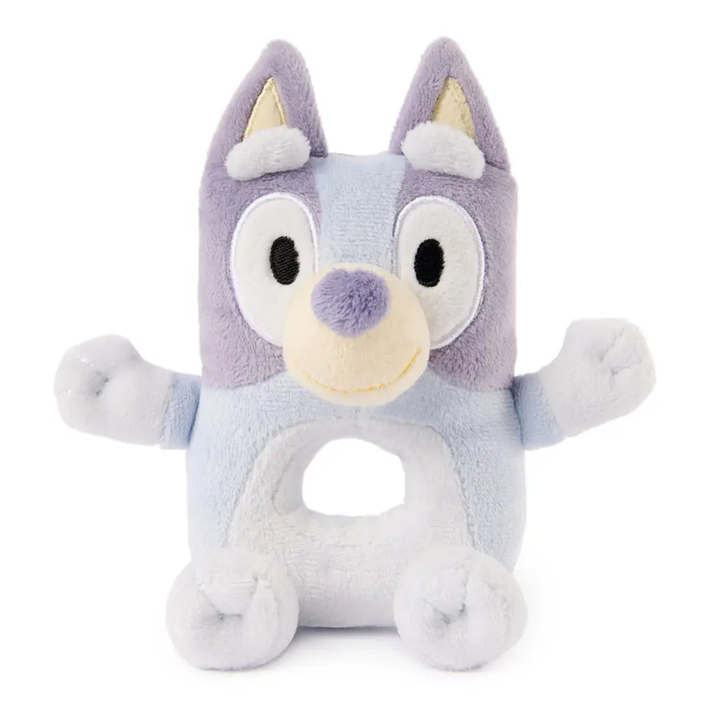 Bluey plush ring rattle presents light blue and lavender plush fabric, embroidered eyes and smile, raised arms, and a soft circular opening, designed for comforting infant play.