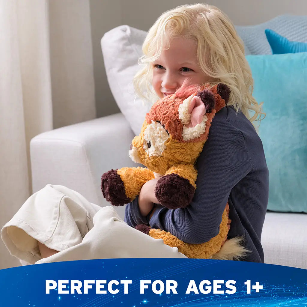 GUND Cozys Disney Bambi plush toy in tan and cream textured fabric with a relaxed, under-stuffed body, hugged by a smiling child indoors to highlight emotional comfort, softness, and toddler-friendly design.