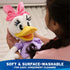 Disney Daisy Duck plush shown being held and cleaned, highlighting soft white plush fabric, yellow beak, lavender shirt, pink bow, and surface-washable design for easy care and everyday use.