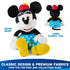 Disney Minnie Mouse plush toy in black and white premium fabric with smooth fuzzy texture, classic seated mouse form, blue satin polka dot skirt, red hat with yellow flower, white gloves, and long floppy tail, shown front and back on white.