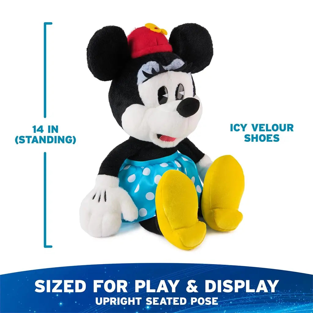 Disney Minnie Mouse plush toy in black, white, and red soft fabric with smooth velour texture, upright seated mouse shape, red hat with yellow flower, blue polka dot skirt, and yellow shoes, shown with 14 inch height on white background.