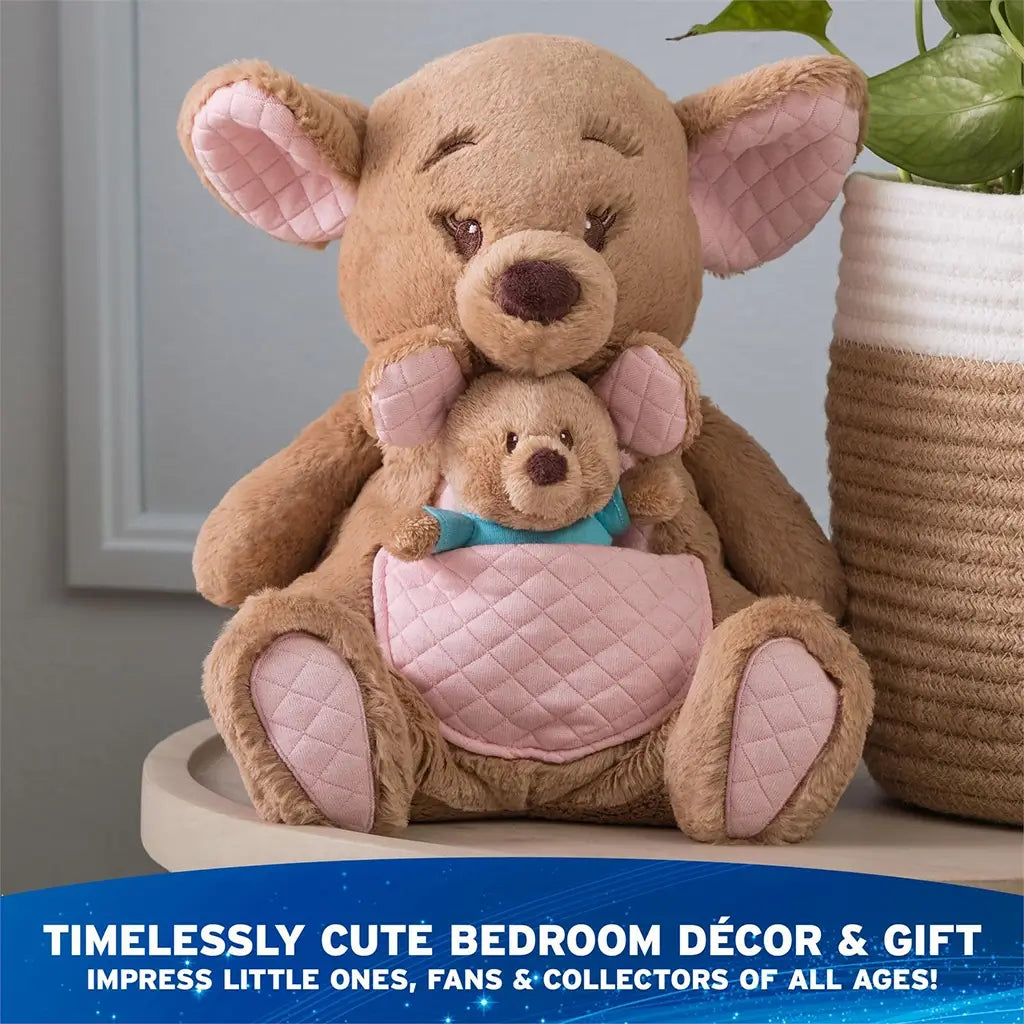 Disney Kanga and Roo plush in warm tan and blush pink jersey cotton with quilted pouch, rounded ears, and soft forms, designed for cuddling and décor, displayed upright on a table in a calm nursery setting.