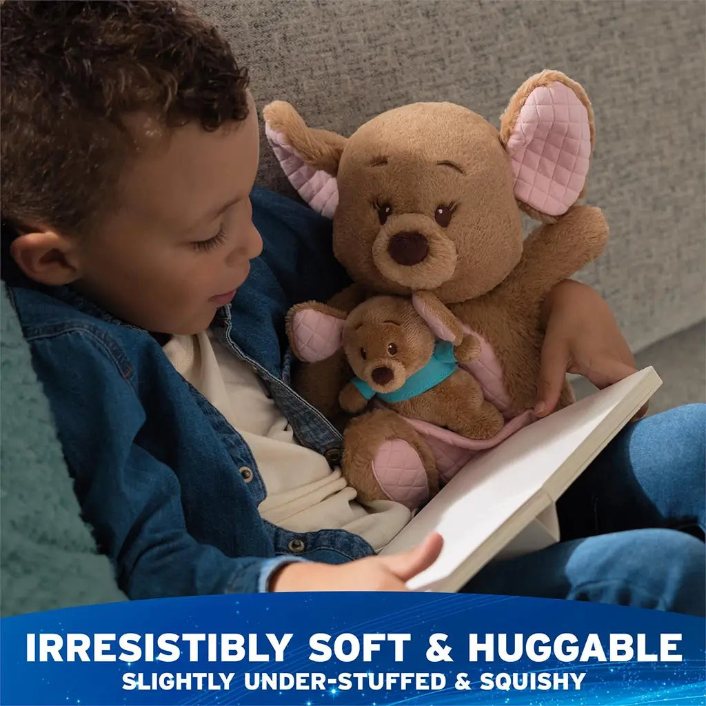 Disney Kanga and Roo plush in warm tan fabric with quilted pink accents, gently under-stuffed for a squishy feel, designed for hugging while a child reads quietly in a relaxed indoor setting.