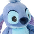 Disney Stitch plush close-up showing light blue and periwinkle plush fabric, smooth stitched facial details, rounded nose, and fuzzy tuft, highlighting soft texture and character design on a white background.