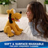 Disney Pluto plush toy in warm yellow fuzzy fabric with seated dog shape, floppy ears, pink tongue, and red collar, shown facing a child on a carpeted floor to highlight soft surface washable care.