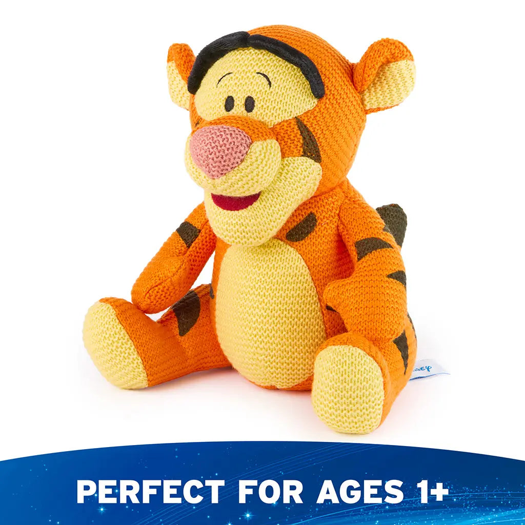 Disney Tigger plush is shown from an angled view, featuring soft knit texture, rounded limbs, expressive embroidered face, and gently curved posture that adds playful character appeal.