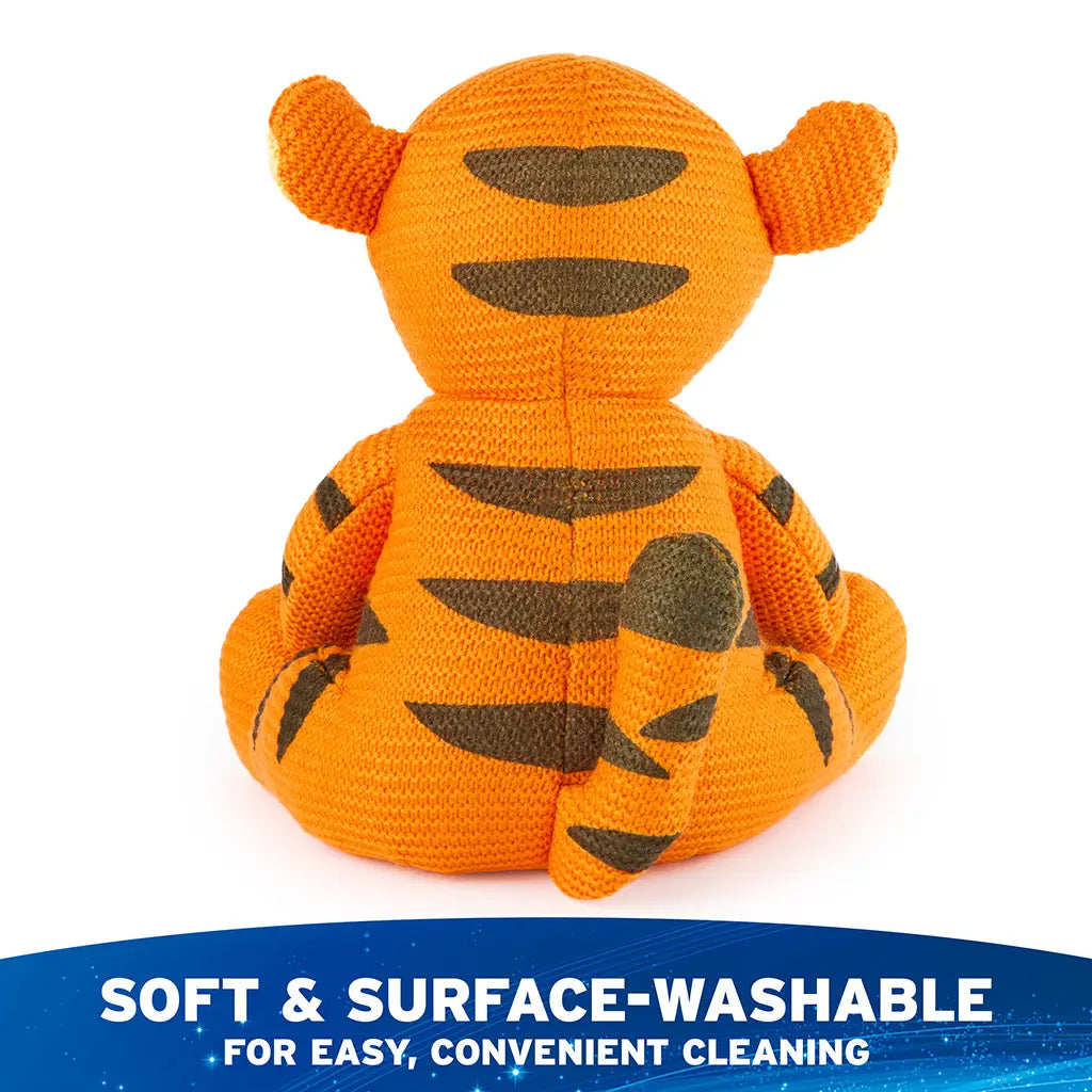 Disney Tigger knit plush is shown from the back, revealing orange knit fabric with brown stitched stripes, rounded tail, and surface-washable construction for easy, convenient cleaning.