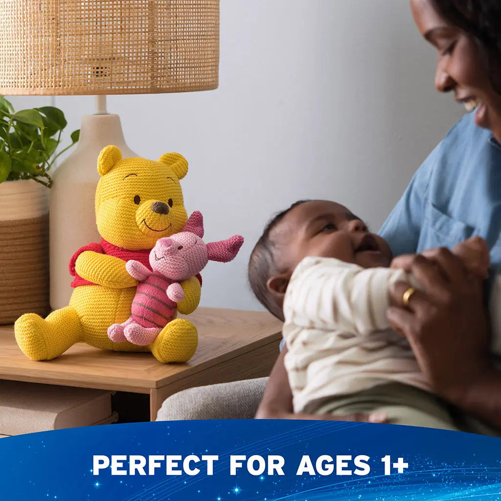 Disney Winnie the Pooh and Piglet knit plush is shown in a cozy nursery setting, featuring soft knit textures, cheerful colors, and an upright seated form that complements bedroom or nursery decor.
