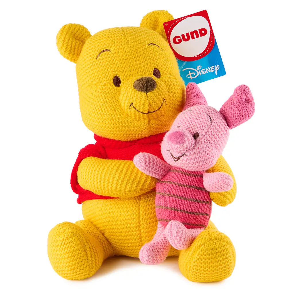 Disney Winnie the Pooh plush holds Piglet in a soft embrace, showcasing yellow and blush knit textures, rounded limbs, stitched facial details, and a classic seated pose made for gentle cuddling.