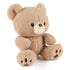 GUND Kai plush teddy bear in light beige fluffy fabric with rounded ears and soft body, angled seated pose showing textured fur and stitched details, small toy on a white background