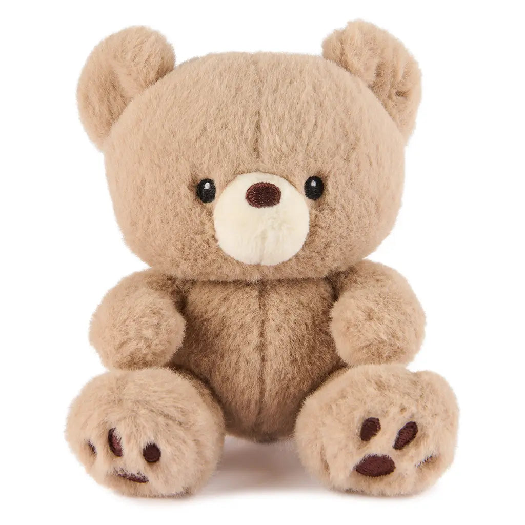 GUND Kai plush teddy bear in light beige fuzzy fabric with rounded shape and paw details, front-facing stuffed toy with embroidered eyes and nose, isolated on a white background