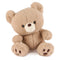 GUND Kai plush teddy bear in light beige soft fabric with rounded body and plush texture, slightly tilted pose emphasizing cuddly form and stitched features, small toy on white background