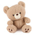 GUND Kai plush teddy bear in light beige soft fabric with rounded body and plush texture, slightly tilted pose emphasizing cuddly form and stitched features, small toy on white background