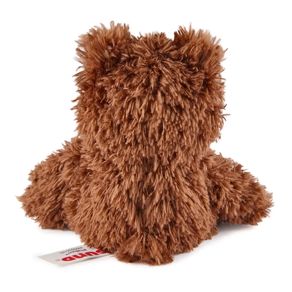 GUND Philbin plush teddy bear in brown shaggy fabric with rounded compact shape and short ears, rear view showing soft texture and tag detail, small cuddly toy on a plain white background