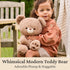 GUND teddy bear lifestyle image showing beige plush fur, soft rounded body, and stitched paw pads, held closely by a child outdoors on a wooden bench, emphasizing the bear’s huggable design and comforting companionship.