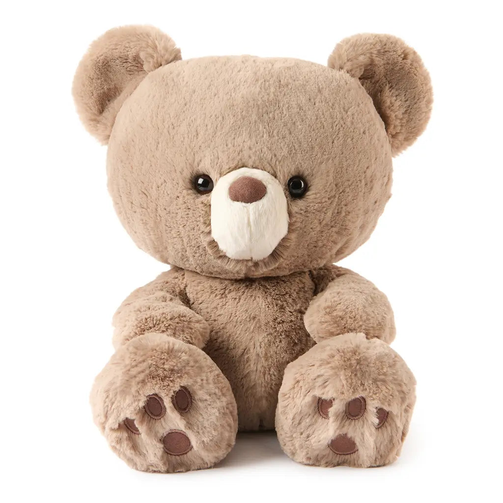 GUND teddy bear product image showing warm beige plush fabric, velvety soft texture, rounded seated shape, stitched paw pads, and balanced proportions, photographed on a white background for clear product viewing.