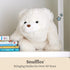 GUND Snuffles teddy bear plush in soft cream fabric with rounded limbs and gentle smile, sitting on a shelf beside children’s books, emphasizing nursery décor appeal and timeless stuffed animal design.