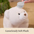 GUND Snuffles plush teddy bear in creamy white ultra-soft polyester fabric with a rounded squishy form, shown being gently brushed to emphasize luxurious softness and premium plush texture.