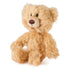 GUND Toothpick plush teddy bear in light tan shaggy fabric with soft rounded body and ears, side angled pose showing texture and stitching, small cuddly toy on a plain white background