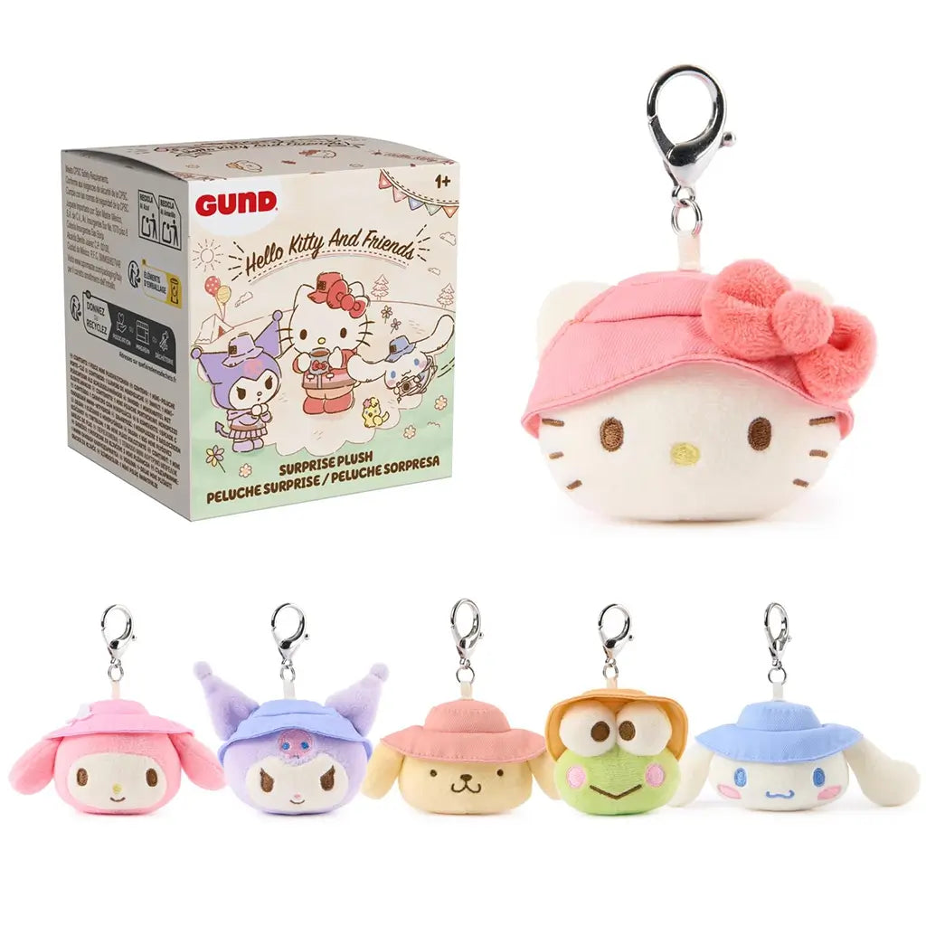 GUND Hello Kitty and Friends camping surprise plush assortment showing multiple pastel character keychains with soft velour texture, rounded shapes, embroidered faces, and silver clips, displayed together on a clean white studio background.