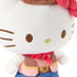 Hello Kitty cowgirl plush close-up showing white velour fabric, smooth rounded face shape, embroidered brown eyes and whiskers, yellow nose stitching, red neckerchief, and detailed western outfit textures against a white background.