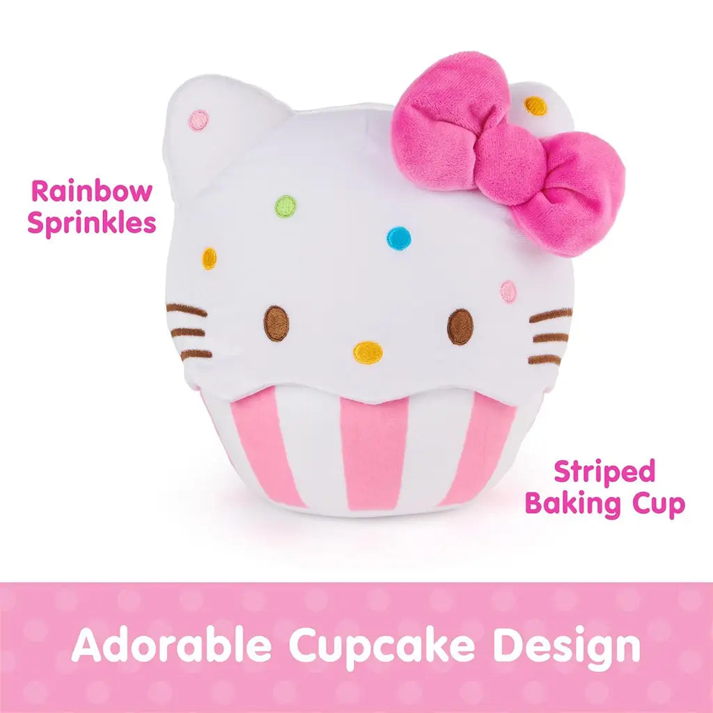 GUND Hello Kitty cupcake plush featuring an adorable cupcake design with white velour frosting texture, rounded form, pink striped baking cup base, colorful embroidered sprinkles, and signature pink bow, photographed on a clean white background.