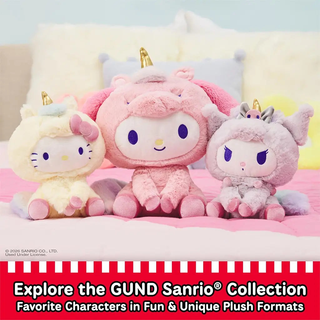 GUND Kuromi plush from the Sanrio collection shown in pastel purple and white velour fabric with soft fuzzy texture, rounded character form, jester-style ears, embroidered skull and facial details, displayed with other Sanrio plush on a pink bed setting.