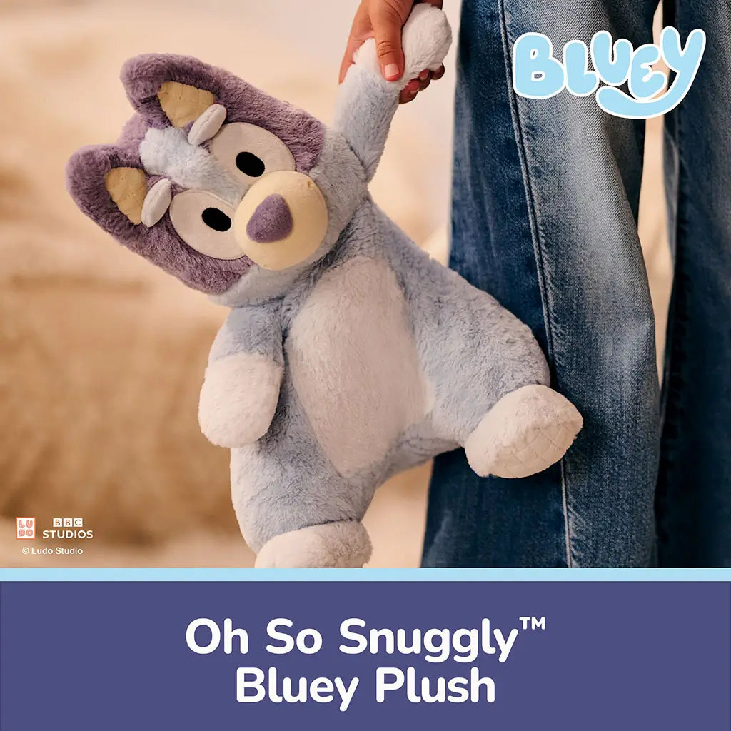 GUND Bluey plush is shown in a warm lifestyle scene with a child, featuring ultra-soft pastel fabric, floppy relaxed form, and friendly embroidered face that encourages imaginative play and everyday snuggling.