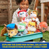 GUND Paw Patrol plush collection in colorful soft fabric including Marshall, Skye, Chase, and others, small rounded dog shapes placed in green wagon outdoors with child playing