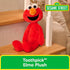 GUND Toothpick Elmo plush displays bright red soft fabric, elongated limbs, and a friendly embroidered face, posed on wooden stairs as decorative yet playful Sesame Street nursery decor.