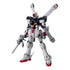 Gundam model kit white and navy plastic humanoid robot with angular armor and red feet, Crossbone Gundam X1 Ver Ka holding rifle with X-shaped backpack, displayed upright on clean white studio background