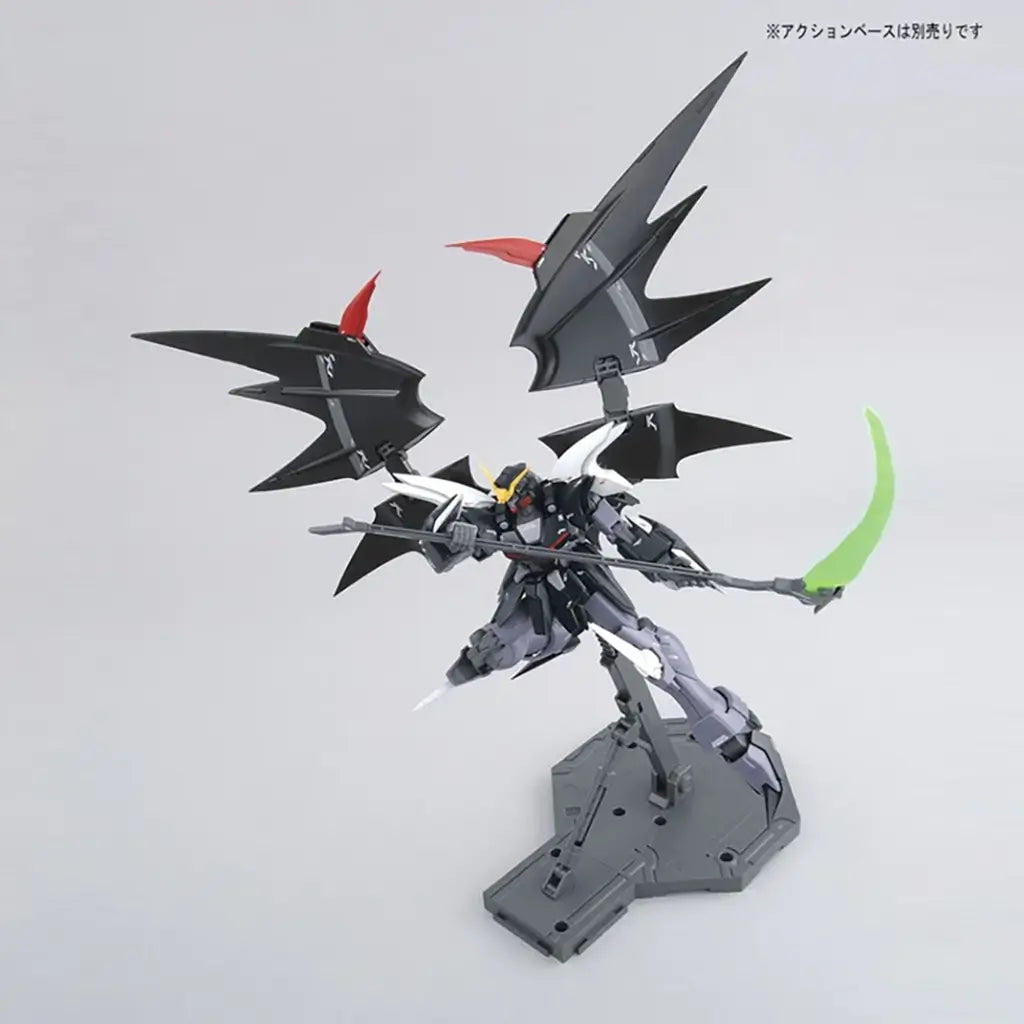 Bandai Gundam Deathscythe Hell model kit in black matte plastic with red and yellow accents, angular winged form wielding a green beam scythe, posed on a display base against a clean white studio background.