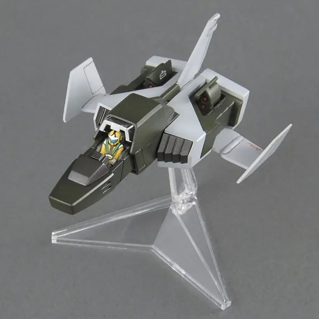 Gundam support aircraft green and white plastic model with sharp angular wings and cockpit, Full Armor Gundam accessory jet displayed on clear stand against neutral gray background