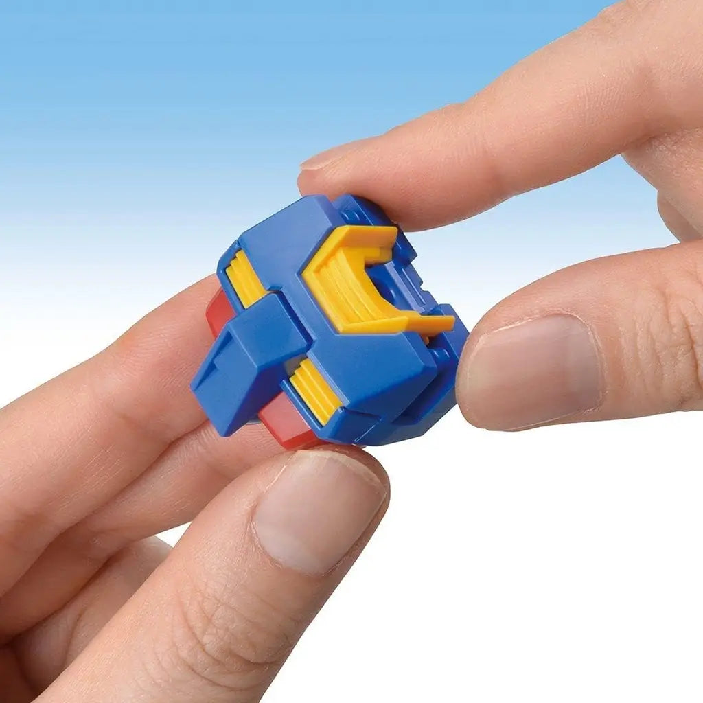 Gundam RX-78-2 model kit runners in blue, yellow, and dark gray plastic with small joint and armor pieces, held between hands to show snap-fit assembly design on a light blue background.