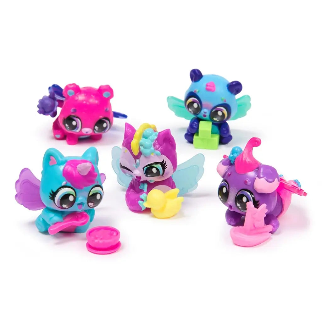 Collection of Hatchimals Alive Neon Rainbow figures in vivid pink, turquoise, blue, and purple hues, featuring wings, textured details, and playful poses on a white background.