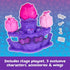Hatchimals Bloomables Flower Fest contents displayed outside packaging, featuring purple plastic stage, pink and magenta flower buds, three collectible characters, translucent wings, and small accessories on a white background.