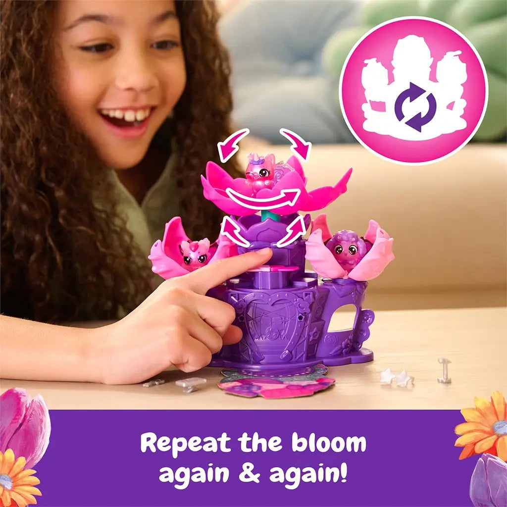 Hatchimals Bloomables Flower Fest twirl and transform feature showing a child pressing the heart button on the purple stage to spin and raise the central flower, demonstrating interactive blooming motion.