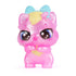 Hatchimals Bloomables character close-up showing translucent pink plastic mini figure with pale yellow accents, large sparkly eyes, folded arms pose, and soft gradient coloring on a clean white background.