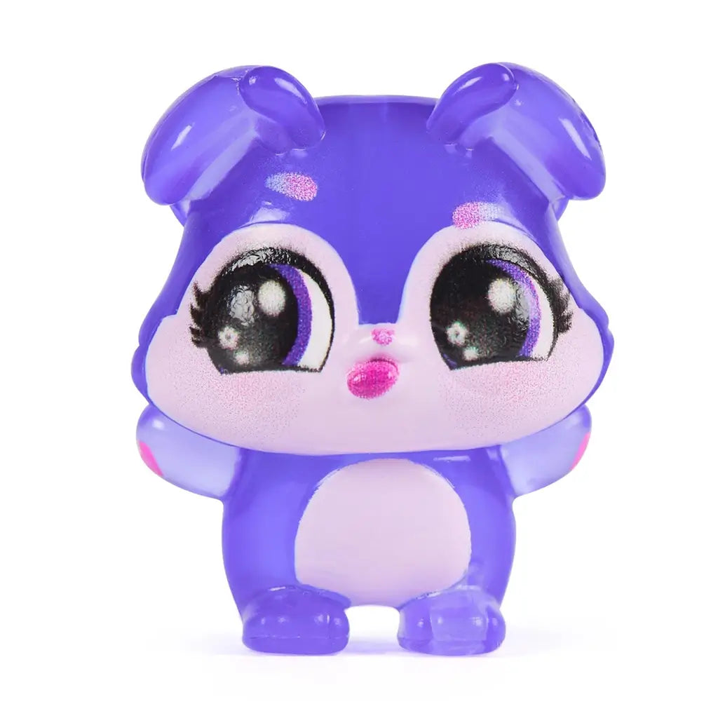 Hatchimals Bloomables collectible character close-up featuring glossy translucent purple mini figure with lavender face, large expressive eyes, rounded ears, and smooth molded details on white background.