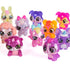 Hatchimals Bloomables collectible characters assortment displayed together, featuring multiple pastel animal figures in pink, purple, orange, blue, and glitter finishes with oversized eyes and rounded toy proportions.