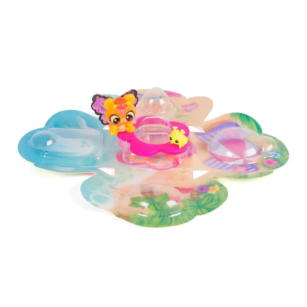 Hatchimals Bloomables floral play area shown opened flat, featuring colorful printed flower-shaped panels, clear plastic domes, and tiny character figures arranged for storytelling and display play.