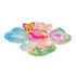 Hatchimals Bloomables floral play area shown opened flat, featuring colorful printed flower-shaped panels, clear plastic domes, and tiny character figures arranged for storytelling and display play.
