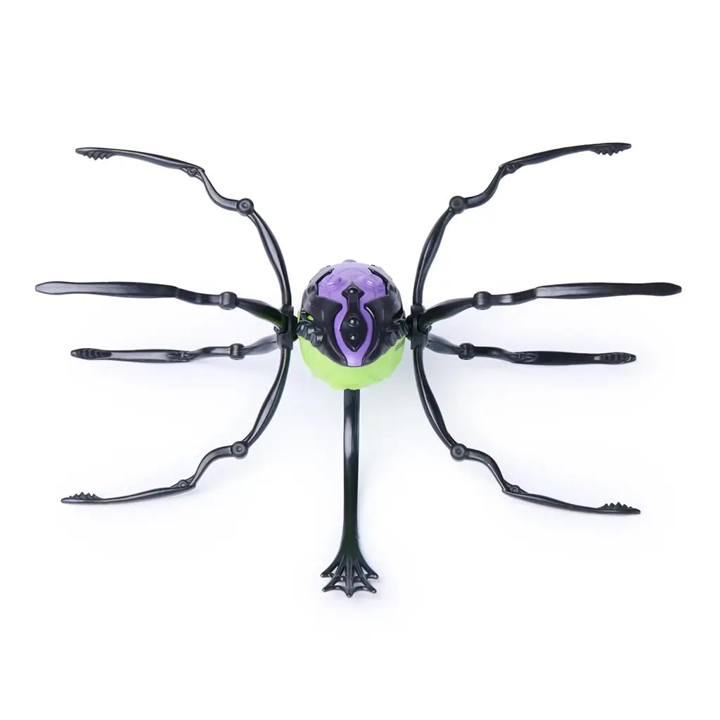 HEX BOTS Skitter Bot spider toy in purple and neon green molded plastic with segmented body and eight black jointed legs spread wide, shown from a top view on a white studio surface. |