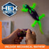 HEX BOTS Wall Crawler glow in the dark gecko in purple and neon green molded plastic with flexible tail and splayed feet, controlled by handheld remote as it climbs a smooth indoor wall.