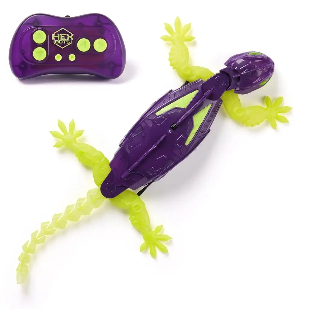 HEX BOTS Wall Crawler remote control gecko in purple and neon green molded plastic with long flexible tail and wide gripping feet, displayed flat on a clean white background.