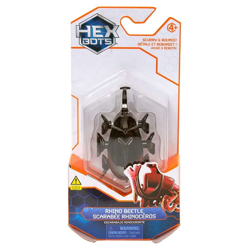 Hex Bots robotic rhino beetle toy in shiny black plastic with prominent curved horn and segmented legs, compact oval body for scurrying and bouncing action, shown in front retail packaging on white background