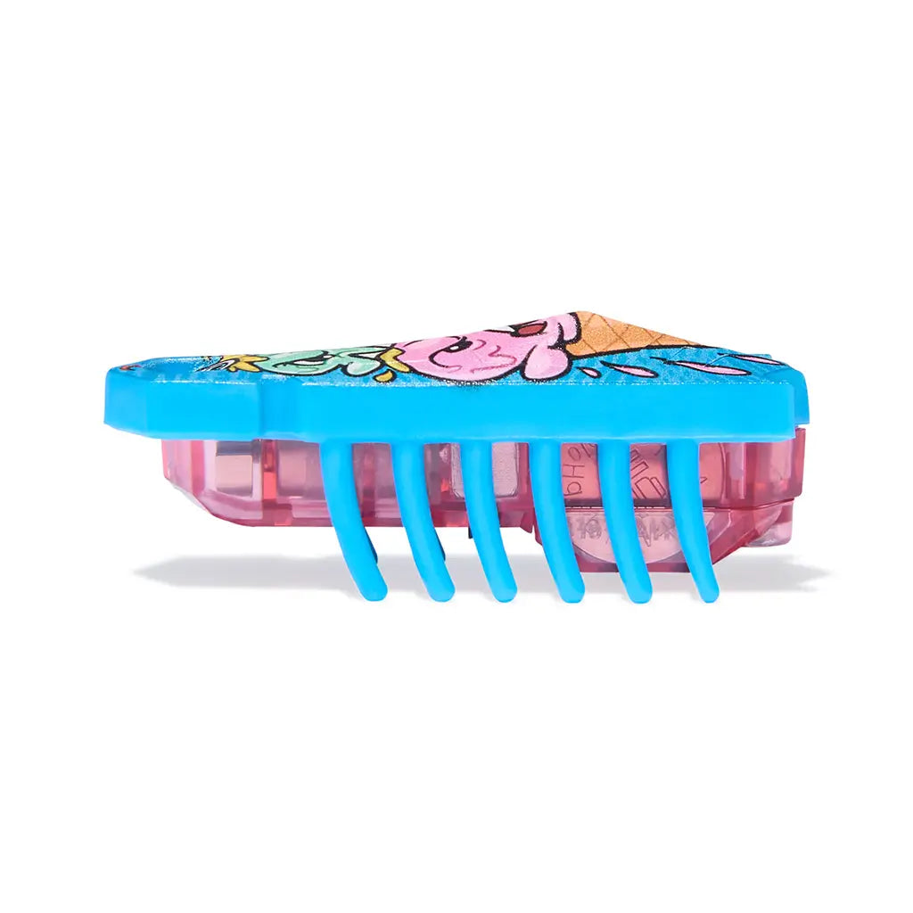 HEXBUG Nano robot bug side view in blue plastic with translucent pink base, low rectangular body and evenly spaced rubber legs, designed for quick vibrating motion on a clean white background.