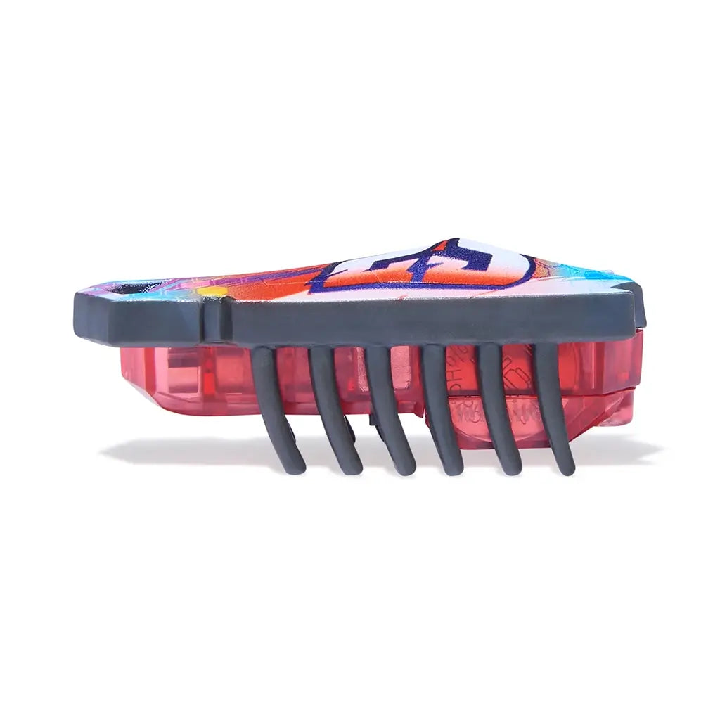 HEXBUG Nano toy robot bright multicolor plastic shell with red translucent base and evenly spaced black legs in a side profile, showing low crawling form designed for fast movement across flat surfaces on white background